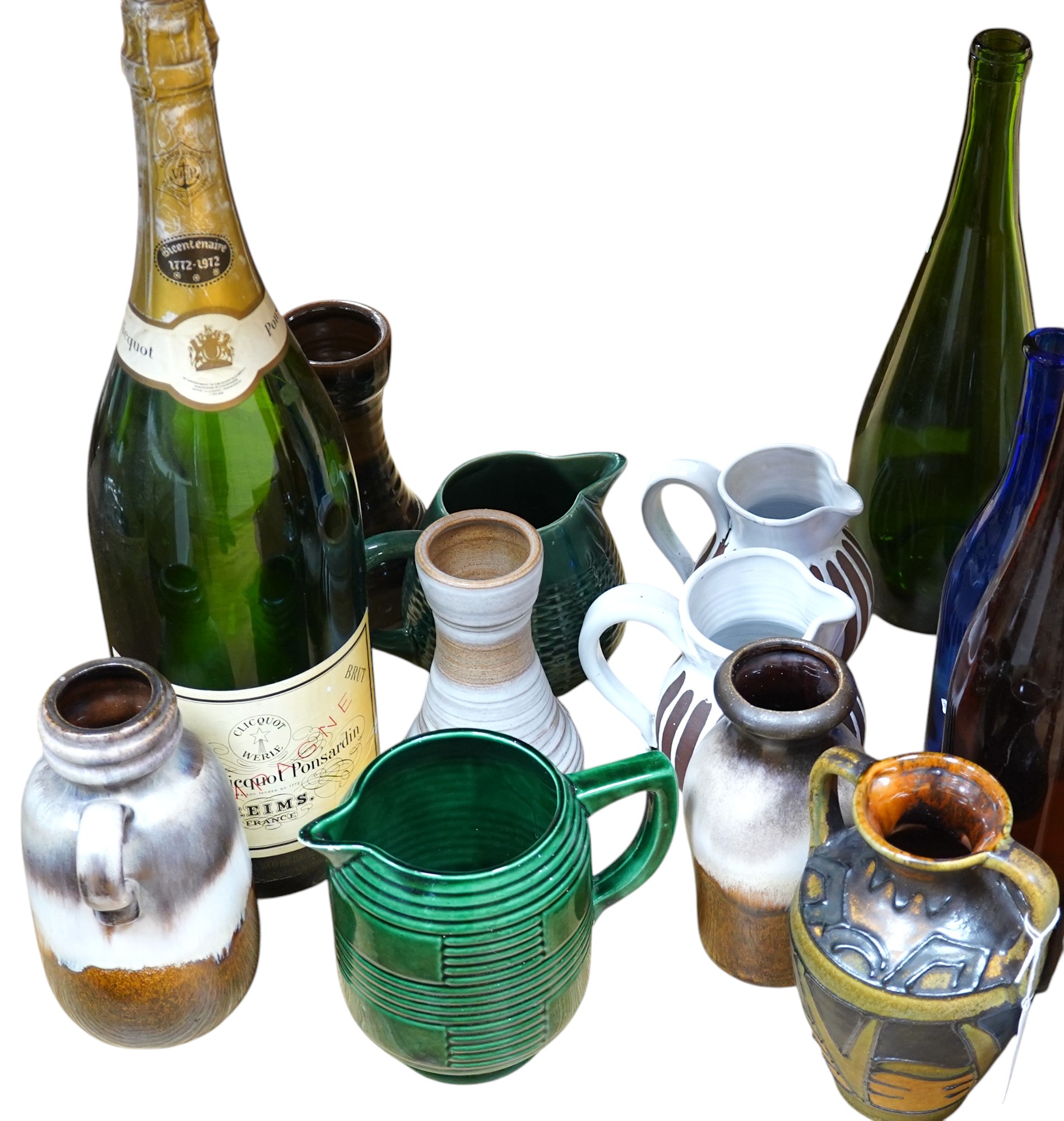 A collection of studio pottery and four glass bottles to include an oversized advertising bottle of Veuve Clicquot Ponsardin - 55cm high. Condition - fair to good